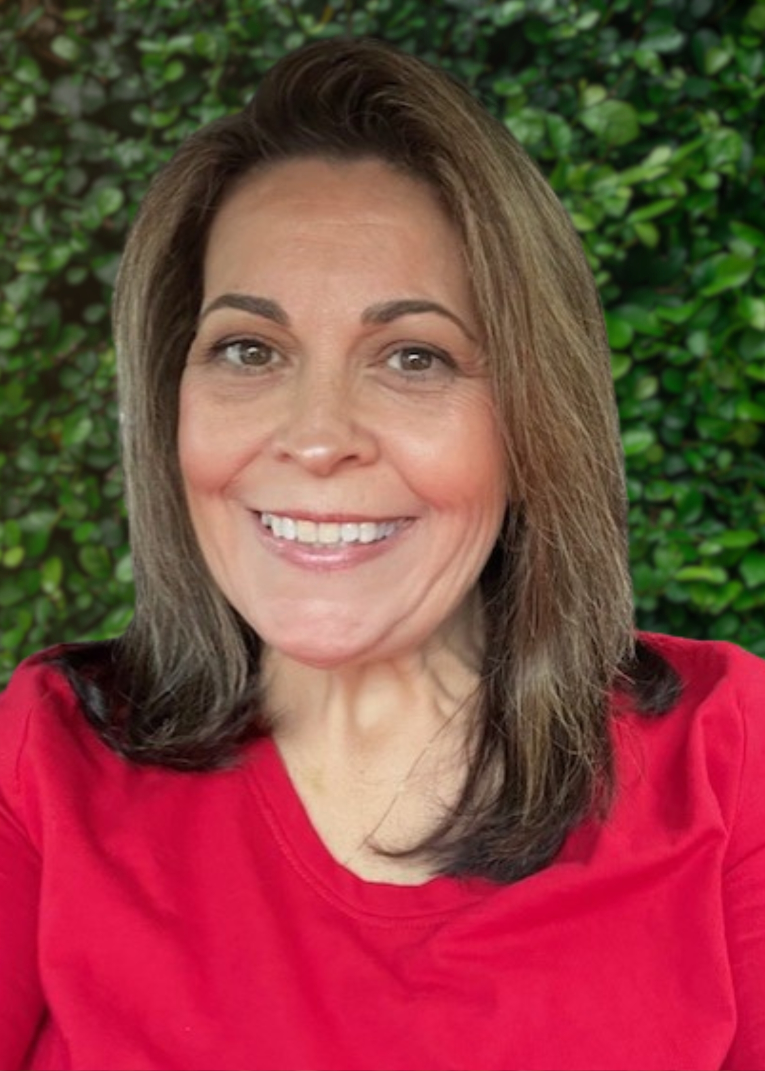 woman with shoulder length hair, wearing a red shirt and smiling